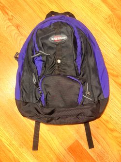 Eastpak multi-compartment daypack in a purple and black color scheme