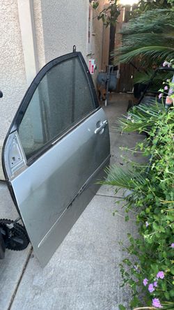 2003-2008 Toyota Corolla driver side door with glass and panel just a little bit bent and dirty still useable.