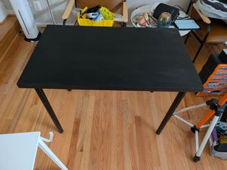 Black Ikea table top with metal legs