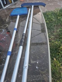 Pool cleaning brush , net & extra long attachment pole for cleaning pool .
