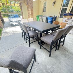 Kitchen table with 7 chairs and bench seat.