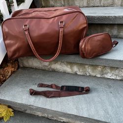 faux brown leather duffle bag with strap and toiletry bag
