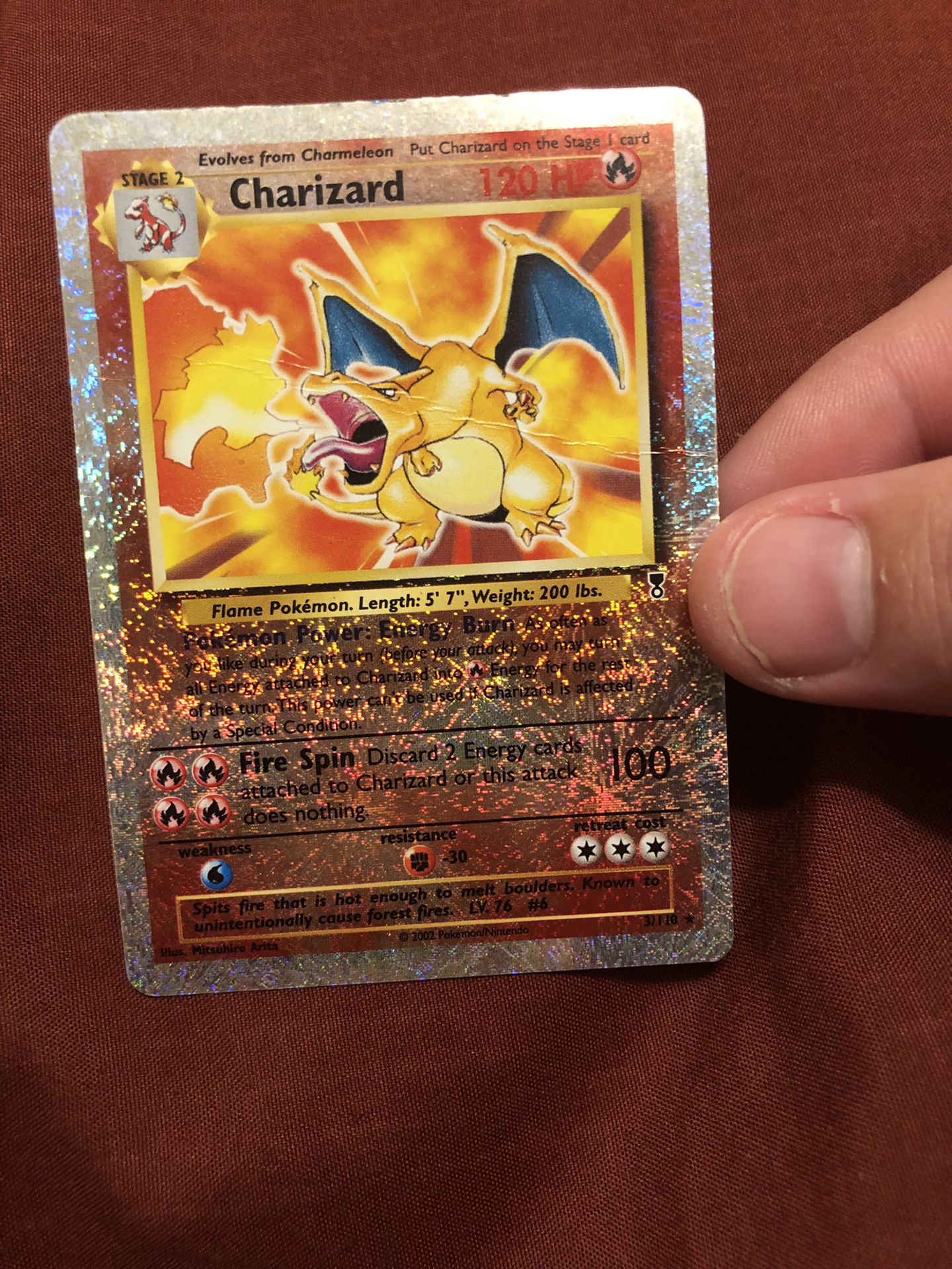 Shiny Charizard card. Rare! (There is a crease across the middle, please see pics provided) $100. The card is in a penny sleeve and top loader