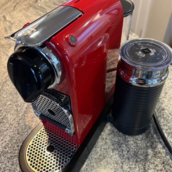 Nespresso machine plus milk frother and $25 worth of pods