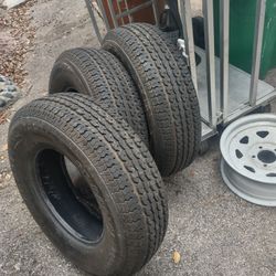 3 Trailer Tires and 1 Galvanized Wheel .