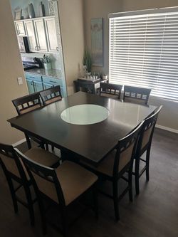 Dining table with cushioned chairs and matching Bar