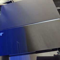 PS4 WITH 2 REMOTES AND 4 GAMES