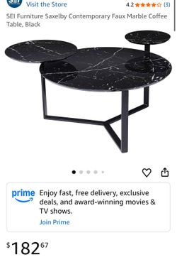 black faux marble nesting coffee table with a tiered design.