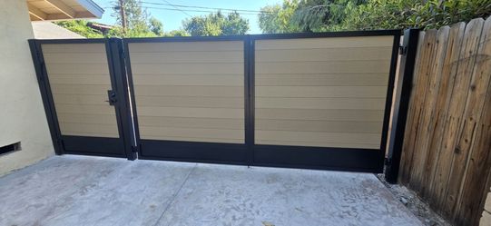 Wrought iron gates and fence with composite wood
