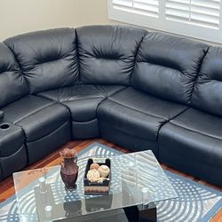 A leather sofa with a queen bed, built-in coffee table
