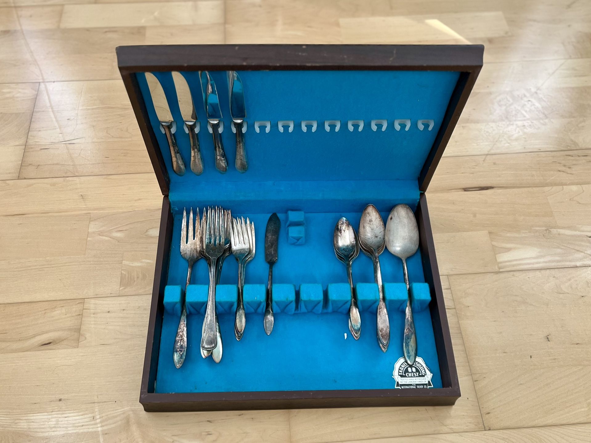 Antique sterling silver-plated silverware in wooden box.
