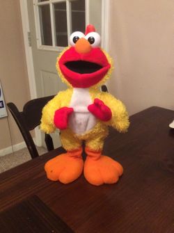Elmo sings and talks. Does the chicken dance.