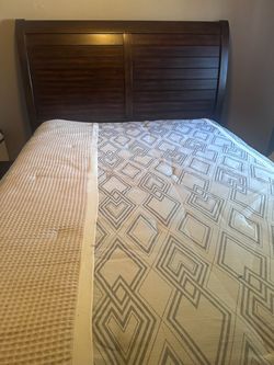 Dark wood bed with mattress