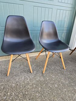 Set of 2 black molded plastic chairs
