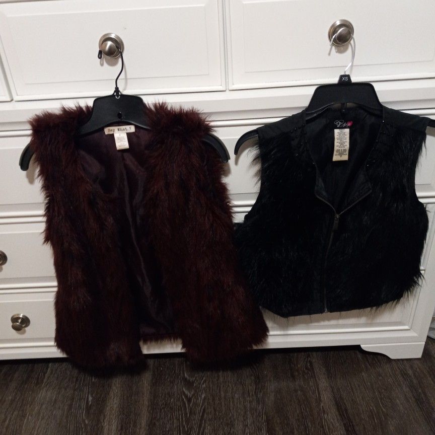 2 Furry Vest. Both Small. One Black... One Brownish Rust Color.