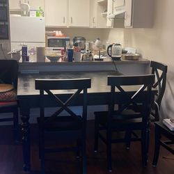 A Large Wooden Square Table With 8 Matching Chairs 
