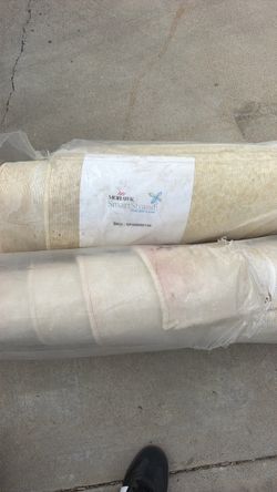 Two white bound pieces of carpet