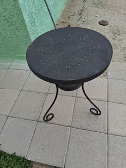 Outside table for chinese checkers to play on the top of it , that's their holes in a table