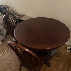 Solid wood circular table with four chairs. Price Negotiable 