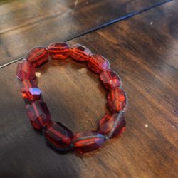 red acrylic bracelet with black string accents