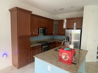 Brown Shaker Cabinets with One Glass Cabinet