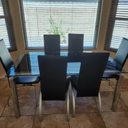 Tinted glass table and six leather chairs modern design