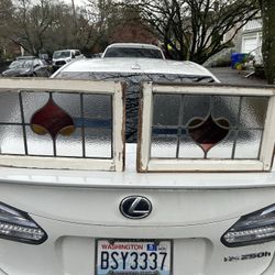 Two matching antique stained glass windows with hooks and small chain-link for hanging  One has a small crack in it but still looks great. $90 for the