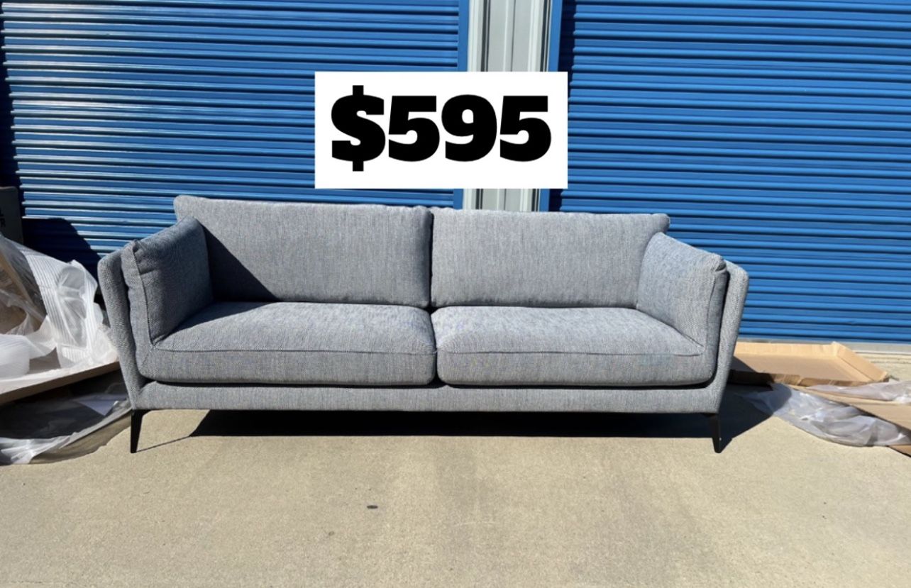 Brand New. Mid Century Modern Sofa. Grey/blue. Retails For $1400. 2 Available. $595 Each