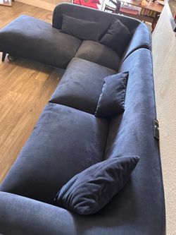 Velvet navy blue sectional couch with four pillows