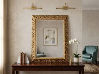 Hollywood Regency style gold ornate wall mirror.