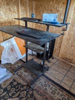 Rolling multilevel desk  and large filing cabinet.