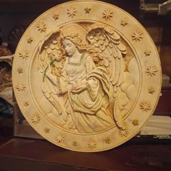 This item is a 3D decorative collector plate featuring a carved angel, likely from the "Hark the Herald Angels Sing Christmas Creche" series by the Br