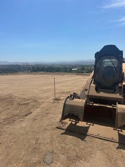 Bobcat leveling grading land clearing