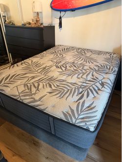 Queen size mattress with gray platform bed frame