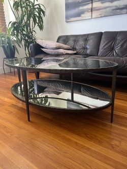 Heavy glass coffer table with hammered steel frame.  Smoked mirror bottom.