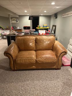 Caramel brown leather love seat