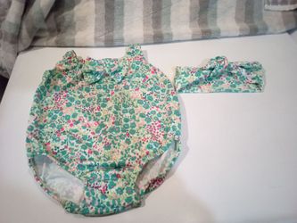 Size 18 months one piece bathing suit with head band .