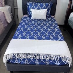 Twin size bed brand new bed frame and a slightly used memory foam mattress.