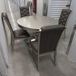 Round gray wooden dining set with 4 upholstered chairs and rhinestone details