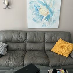 Gray couch loveseat and chair.