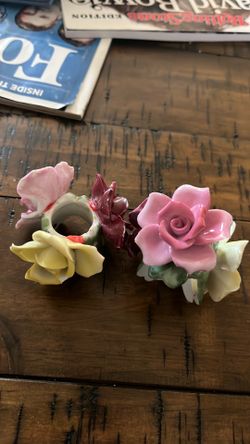 vintage porcelain flower napkin rings or taper candle holders,