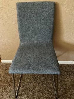 Modern gray upholstered chair with metal legs