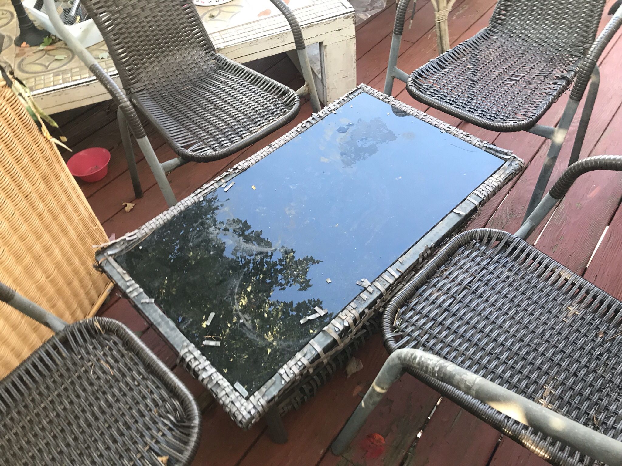 A Beautiful  Patio Set With  Garden Stuff On The Glass Table