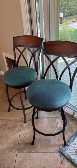 Set up two swivel metal and wood barstools
