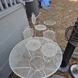 Vintage wrought iron patio set. Only has 3 white chairs but will throw other chair in. Make offer