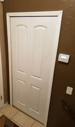 One - 2 Panel Arch Top Bi-fold Closet Door - $25