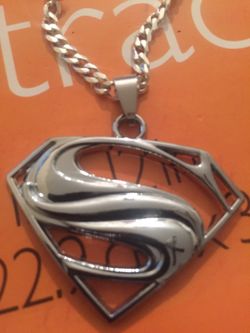 Brand-new sterling silver chain and Superman pendent. 30inch 4mm wide long chain
