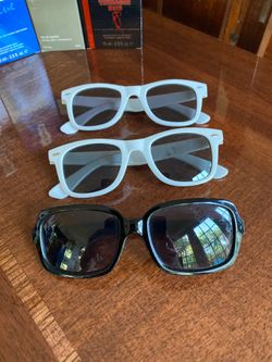 Three pairs of sunglasses. Two white frame one black frame