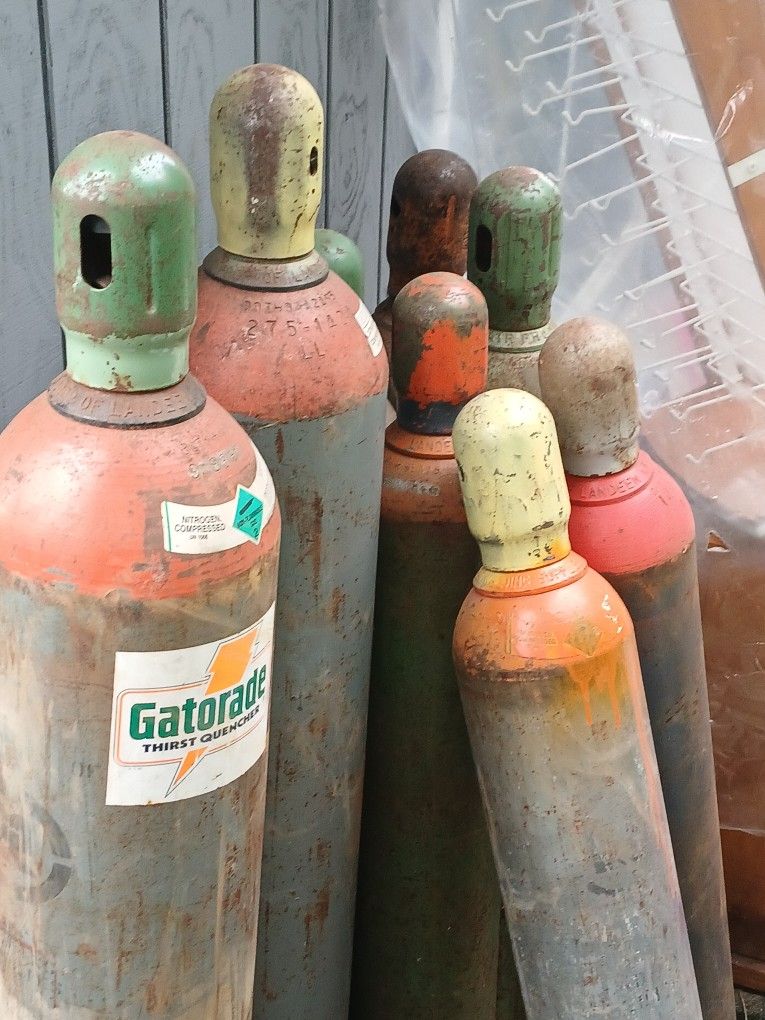 Gas Cylinders of varying sizes. Both full and empty cylinders are available.