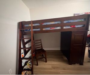 Wooden loft bed with mattress